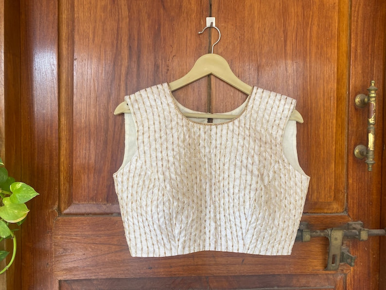Cream sleeveless hand embroidery blouse