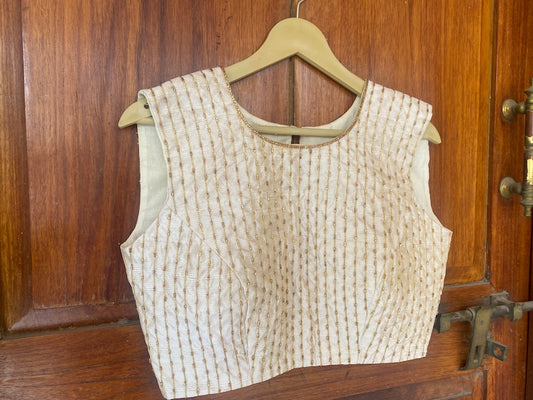 Cream sleeveless hand embroidery blouse