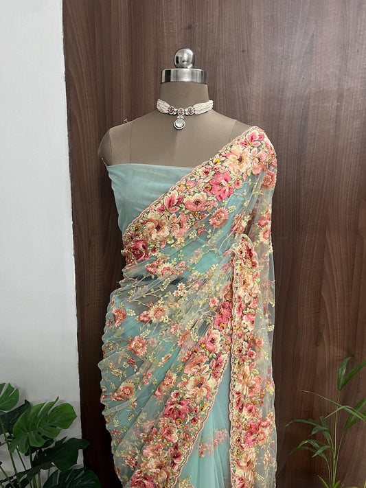 Beautiful cyan blue color net saree with multi color floral embroidery