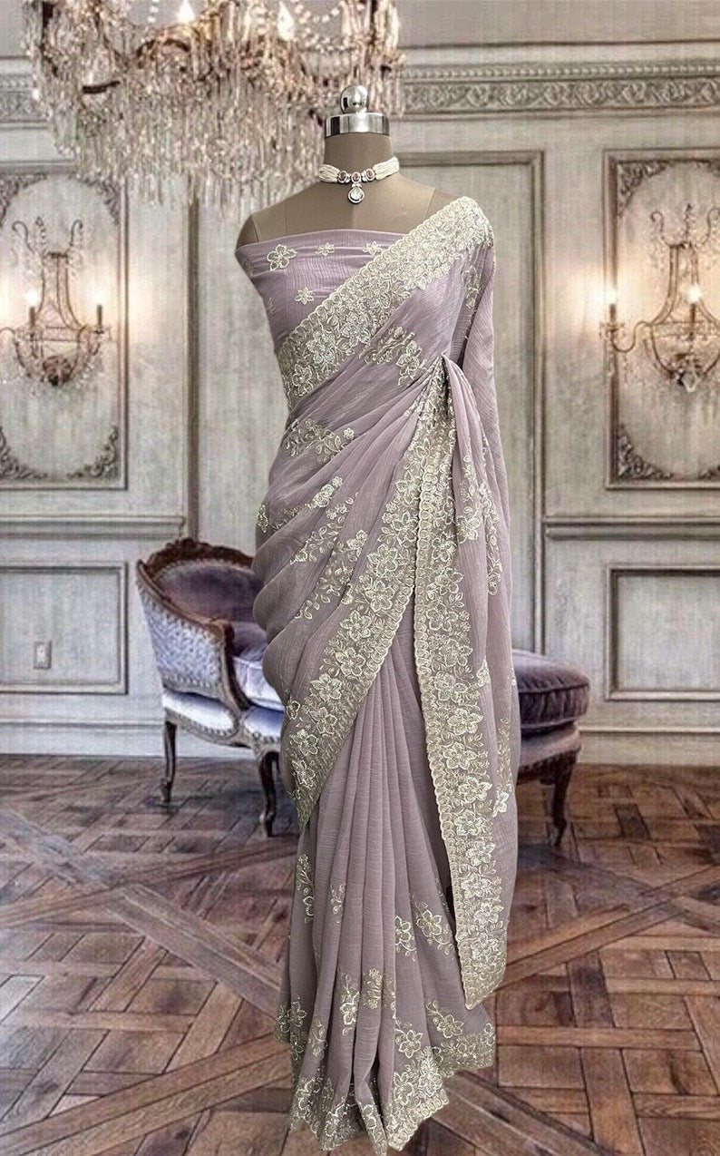 Beautiful pastel pink net saree with thread and stones work