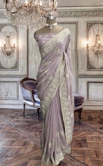 Beautiful pastel pink net saree with thread and stones work