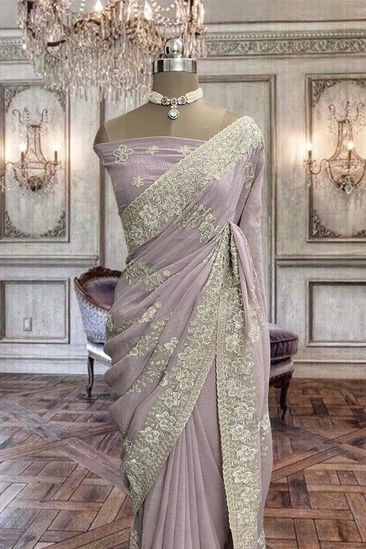 Beautiful pastel pink net saree with thread and stones work