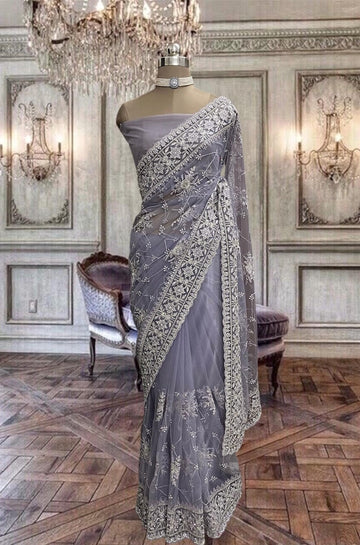 Beautiful light violet color net saree with zari and stone work