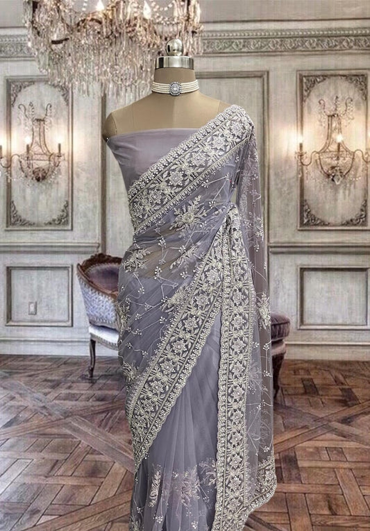 Beautiful light violet color net saree with zari and stone work